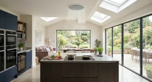 An open-plan kitchen area utilising ceiling-integrated extraction as a discreet cooker hood alternative.