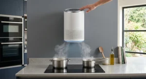 A stylish wall-mounted air purifier serving as a compact cooker hood alternative above a hob.